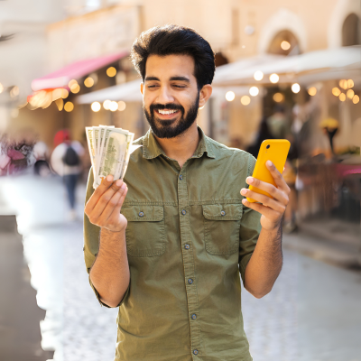 Person with cash and smartphone representing instant loans